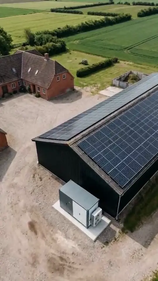 A muted loop of a slow aerial drift over a farm with rows of solar panels