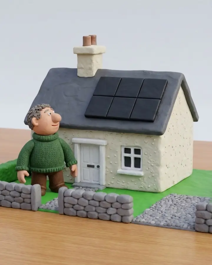 An approved clay still of a man in front of an Irish house looking up at black solar panels on the roof