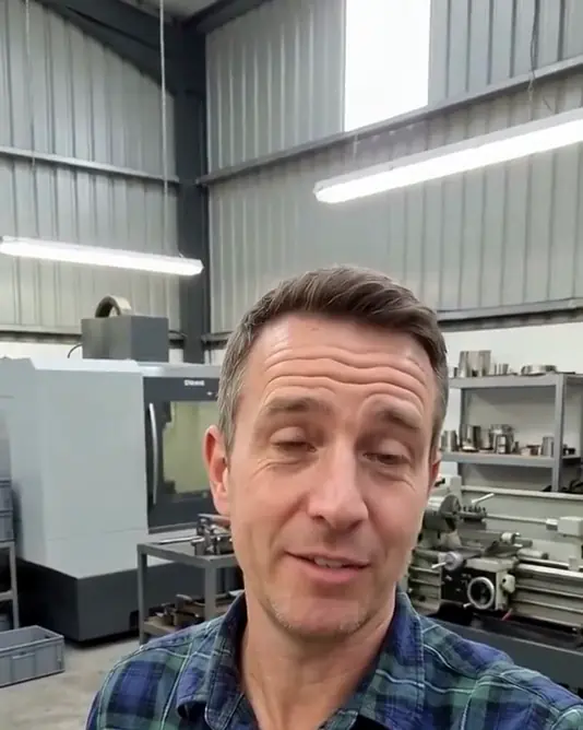 A muted loop of an AI-generated man talking to the camera in a workshop with machines behind him, from one of our ads